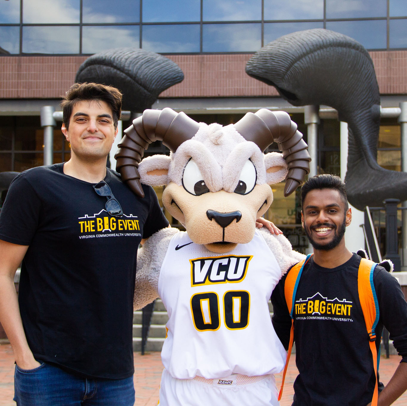 Rodney Ram posing with two students in front of the Ram Horns