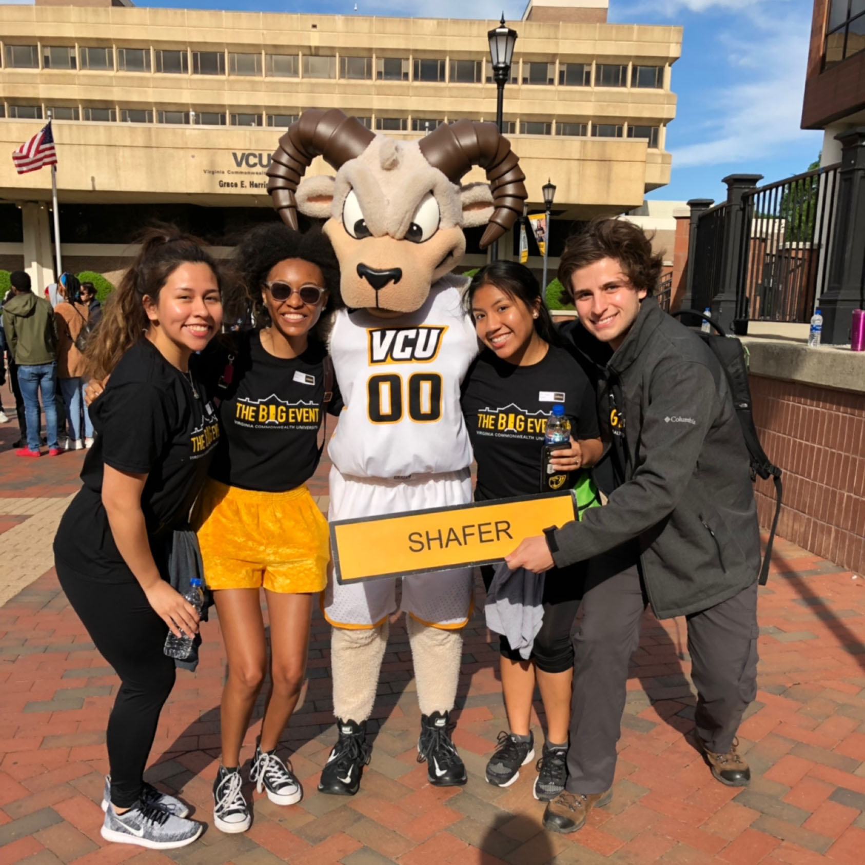 Rodney Ram posing with four students in front of Harris Hall