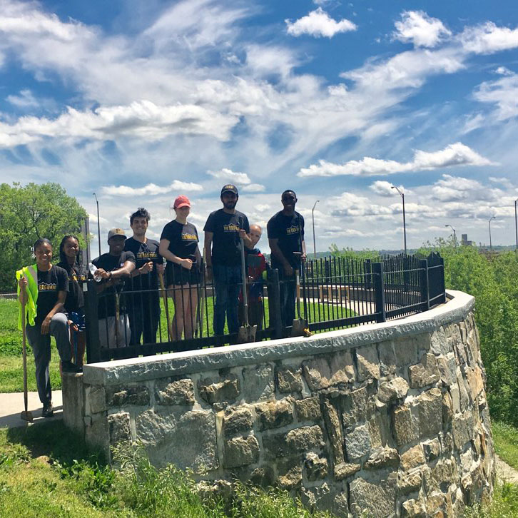 Eight students standing at a park overlook.